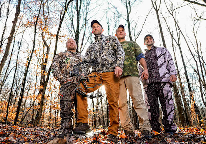 Melillo (holding bow) with Wayne Davis (second from right), who helped track the bear, and hunting buddies Marc Yodice and Jason Famularo.